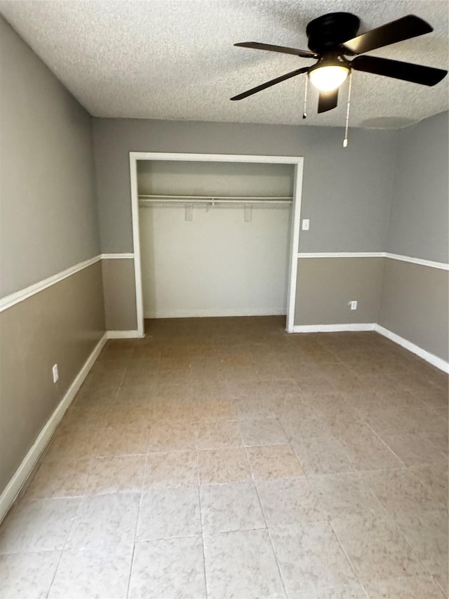 5412 Brookhollow Dr, Sachse, TX 75048 - unfurnished bedroom featuring a textured ceiling, a closet, ceiling fan, and baseboards