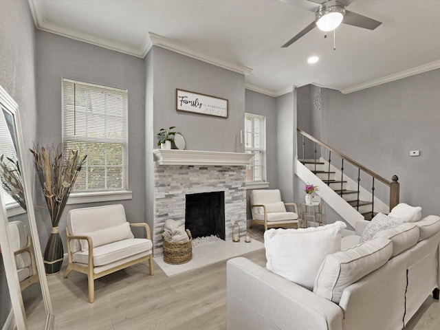 3708 Colonial Ave, Dallas, TX 75215 - living area featuring light wood-style flooring, ornamental molding, ceiling fan, stairway, and a fireplace