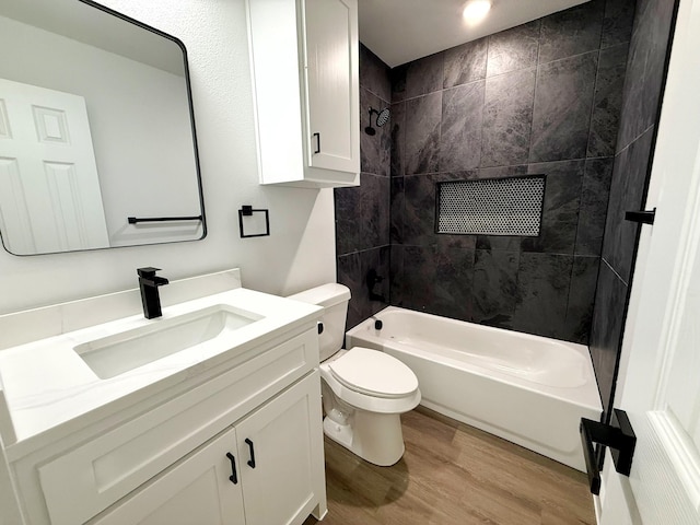 1315 Oneal St, Commerce, TX 75428 - full bathroom with wood finished floors, vanity, toilet, and bathing tub / shower combination