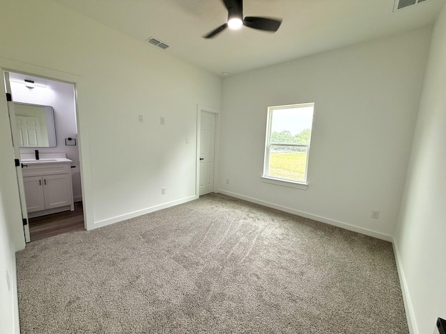 1315 Oneal St, Commerce, TX 75428 - unfurnished bedroom featuring carpet, baseboards, and ensuite bathroom
