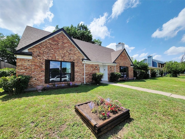 2317 Woodhollow Ave, Mesquite, TX 75150 - traditional home featuring a front lawn, brick siding, a chimney, and roof with shingles