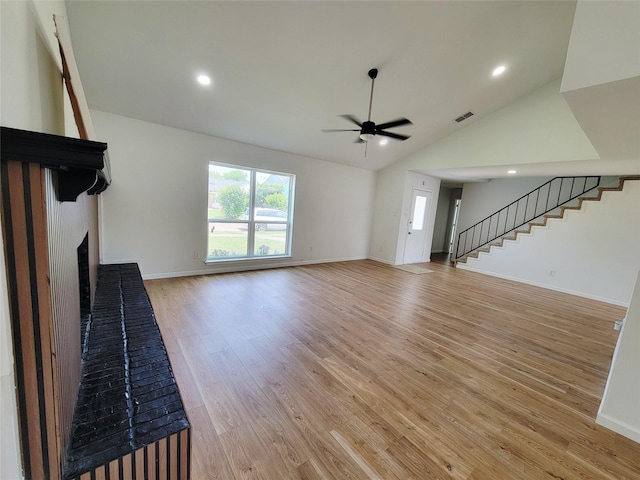 2317 Woodhollow Ave, Mesquite, TX 75150 - unfurnished living room with a fireplace, a ceiling fan, lofted ceiling, stairway, and light wood-type flooring