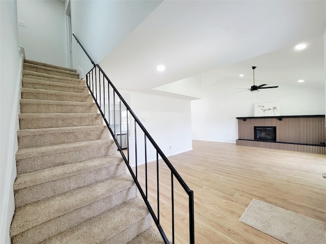 2317 Woodhollow Ave, Mesquite, TX 75150 - stairway with wood finished floors, ceiling fan, a glass covered fireplace, recessed lighting, and vaulted ceiling