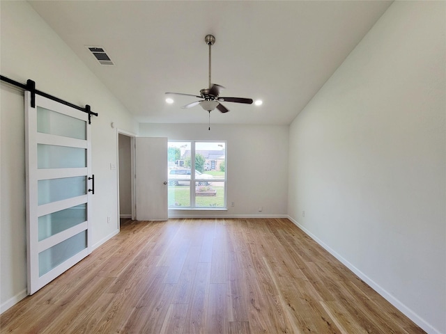 2317 Woodhollow Ave, Mesquite, TX 75150 - spare room featuring a barn door, a ceiling fan, light wood-style floors, baseboards, and recessed lighting