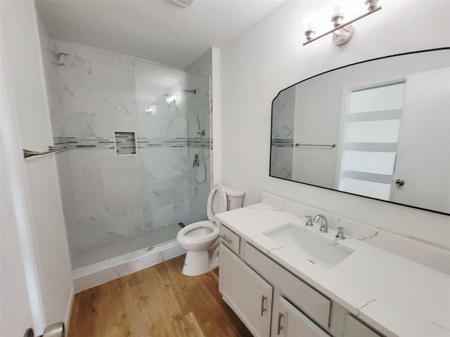 2317 Woodhollow Ave, Mesquite, TX 75150 - bathroom featuring toilet, a marble finish shower, vanity, and wood finished floors