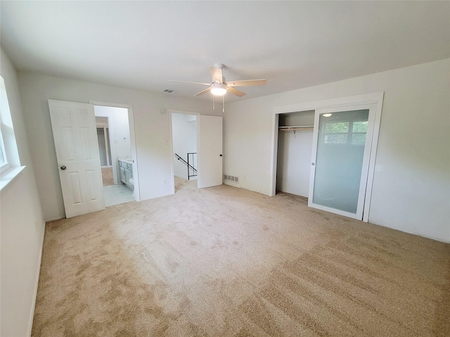 2317 Woodhollow Ave, Mesquite, TX 75150 - unfurnished bedroom with light colored carpet, a closet, a ceiling fan, and connected bathroom