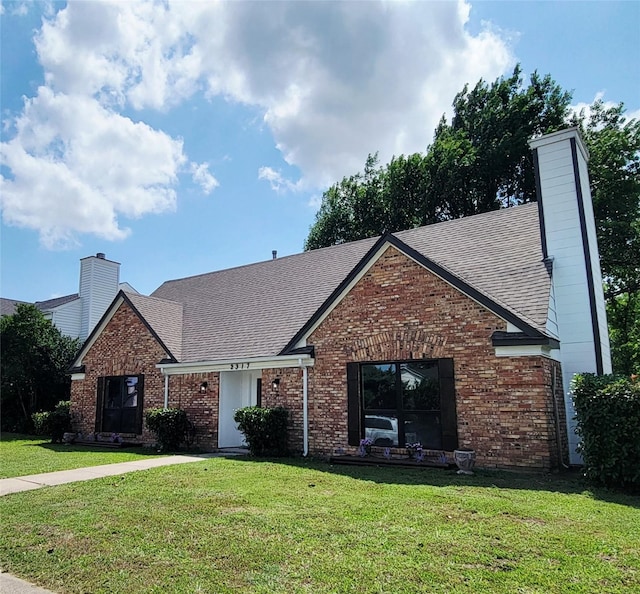 2317 Woodhollow Ave, Mesquite, TX 75150 - traditional-style house with a chimney, a front yard, a shingled roof, and brick siding