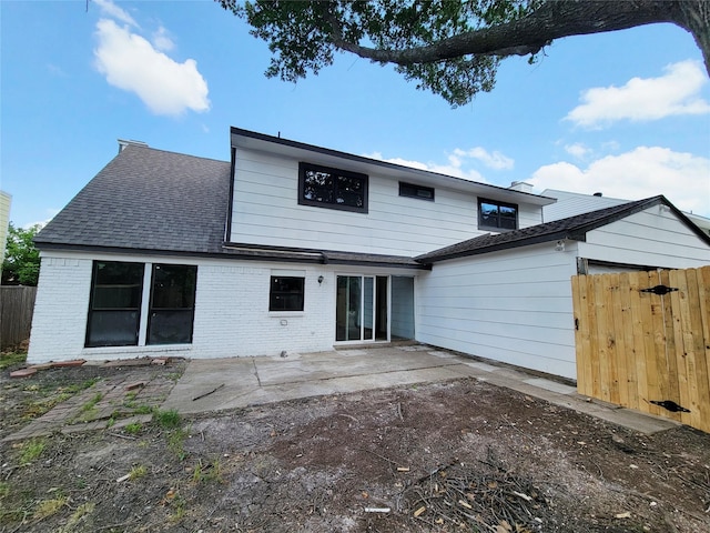 2317 Woodhollow Ave, Mesquite, TX 75150 - back of house featuring brick siding, a patio, and a shingled roof