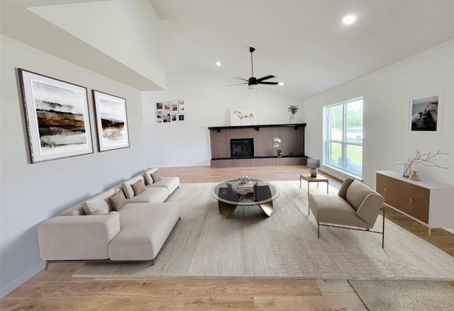 2317 Woodhollow Ave, Mesquite, TX 75150 - living room featuring a ceiling fan, a fireplace, vaulted ceiling, wood finished floors, and recessed lighting