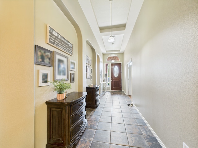 1409 Stoney Hills Dr, Cedar Hill, TX 75104 - doorway to outside featuring arched walkways, a tray ceiling, and baseboards