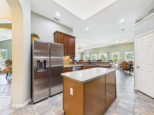 1409 Stoney Hills Dr, Cedar Hill, TX 75104 - kitchen featuring appliances with stainless steel finishes, a sink, a kitchen island, a peninsula, and light countertops