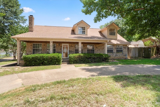 410 Etheridge Rd, Canton, TX 75103 - cape cod-style house featuring a chimney, brick siding, a porch, and a shingled roof