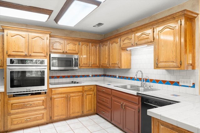 410 Etheridge Rd, Canton, TX 75103 - kitchen featuring black appliances, a sink, decorative backsplash, tile counters, and light tile patterned floors