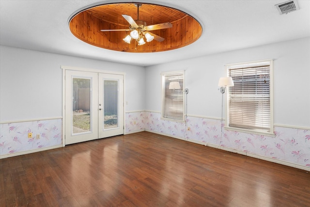 410 Etheridge Rd, Canton, TX 75103 - unfurnished room with french doors, wood finished floors, wallpapered walls, a raised ceiling, and baseboards