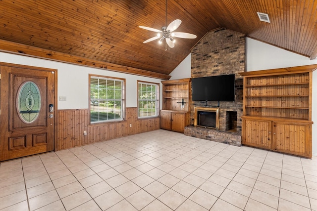 410 Etheridge Rd, Canton, TX 75103 - unfurnished living room with wainscoting, wooden ceiling, ceiling fan, a brick fireplace, and wood walls