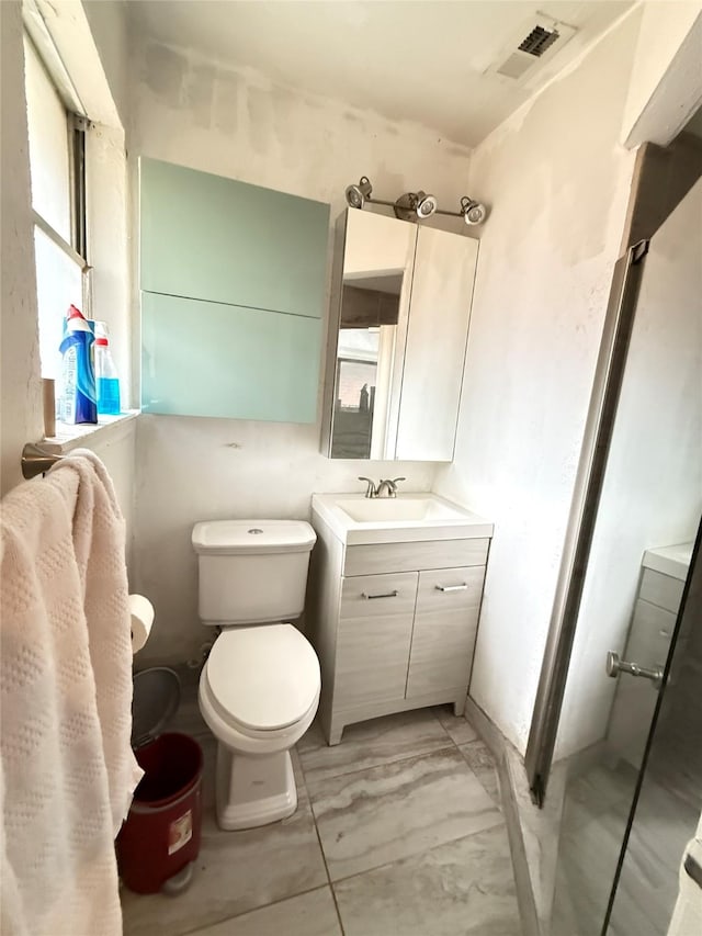 3106 Marydale Rd, Garland, TX 75041 - bathroom with vanity, toilet, and marble look tile flooring