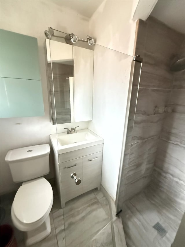 3106 Marydale Rd, Garland, TX 75041 - bathroom featuring a shower stall, vanity, marble look tiles, and toilet