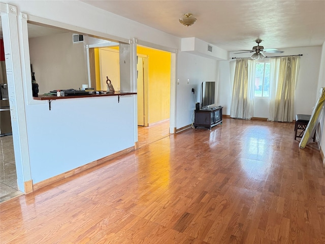 3106 Marydale Rd, Garland, TX 75041 - unfurnished living room with a ceiling fan, light wood-style flooring, and baseboards