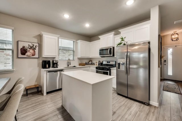 1568 Glacier Rdg, Royse City, TX 75189 - kitchen with appliances with stainless steel finishes, a sink, light wood-style floors, light countertops, and recessed lighting