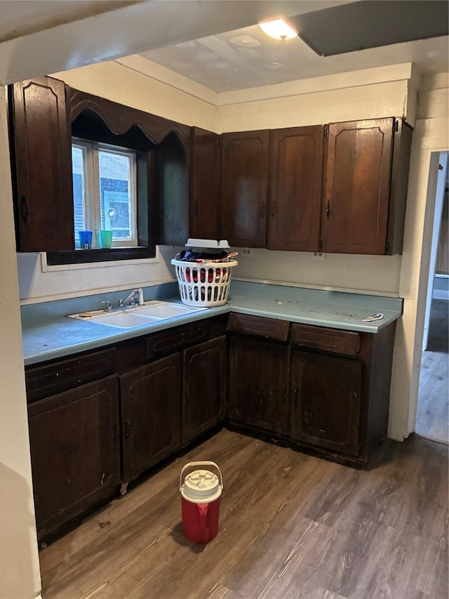 1435 Natalie St, Shreveport, LA 71108 - kitchen with a sink, wood finished floors, dark brown cabinetry, and light countertops