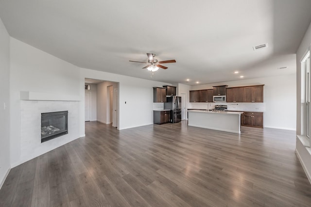 1221 Coralberry Dr, Northlake, TX 76226 - unfurnished living room with recessed lighting, a ceiling fan, baseboards, a sink, and dark wood-type flooring