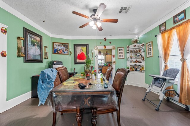 1615 Mitchell Ave, Waco, TX 76708 - dining space featuring ceiling fan, wood finished floors, baseboards, crown molding, and a textured ceiling
