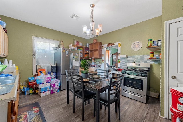 1615 Mitchell Ave, Waco, TX 76708 - dining space featuring a chandelier, wood finished floors, and a textured wall