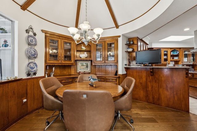 7422 Whispering Pines Dr, Dallas, TX 75248 - dining area with a chandelier, wood walls, a wainscoted wall, and wood finished floors