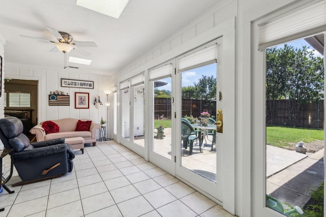 7422 Whispering Pines Dr, Dallas, TX 75248 - living room featuring a skylight, ceiling fan, and light tile patterned floors