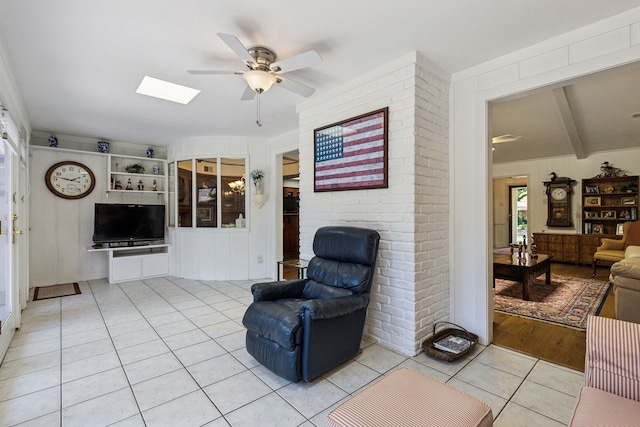 7422 Whispering Pines Dr, Dallas, TX 75248 - living room with a ceiling fan, light tile patterned floors, and a skylight