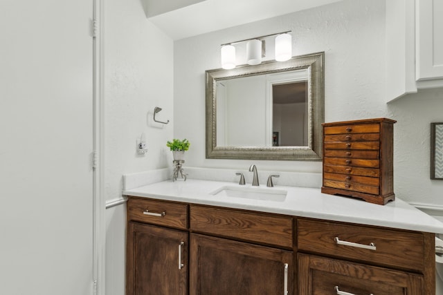 7422 Whispering Pines Dr, Dallas, TX 75248 - bathroom featuring vanity and a textured wall