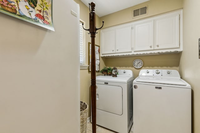 7422 Whispering Pines Dr, Dallas, TX 75248 - laundry area with cabinet space, washer and clothes dryer, and light tile patterned floors