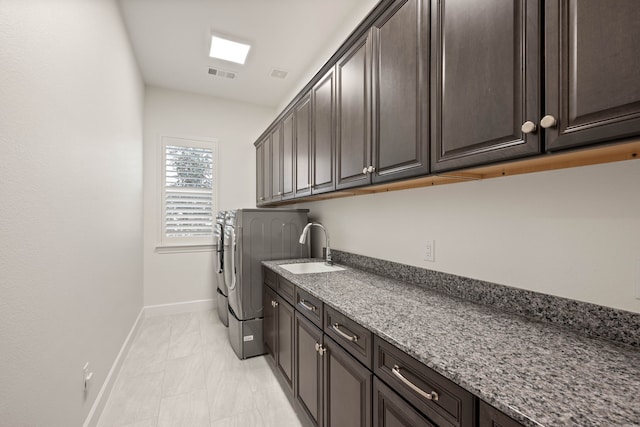 12305 Glenbrook St, Denton, TX 76207 - laundry room featuring cabinet space, washing machine and dryer, and baseboards