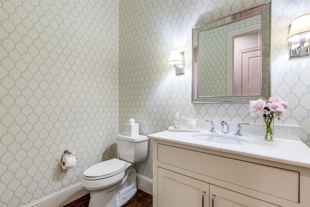 3929 Lively Ln, Dallas, TX 75220 - half bathroom with wallpapered walls, toilet, vanity, and wood finished floors