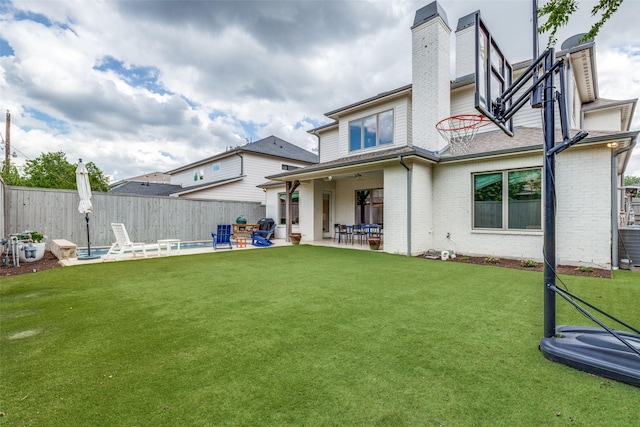3929 Lively Ln, Dallas, TX 75220 - rear view of house featuring a patio area, brick siding, and a chimney