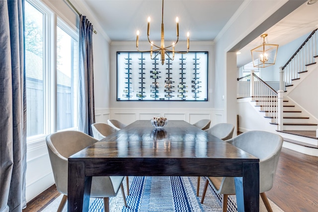 3929 Lively Ln, Dallas, TX 75220 - dining area featuring a chandelier, wood finished floors, ornamental molding, stairway, and a decorative wall