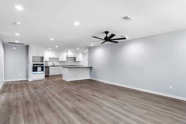 1816 Evans Dr, Waco, TX 76705 - unfurnished living room with baseboards, recessed lighting, ceiling fan, wood finished floors, and a sink