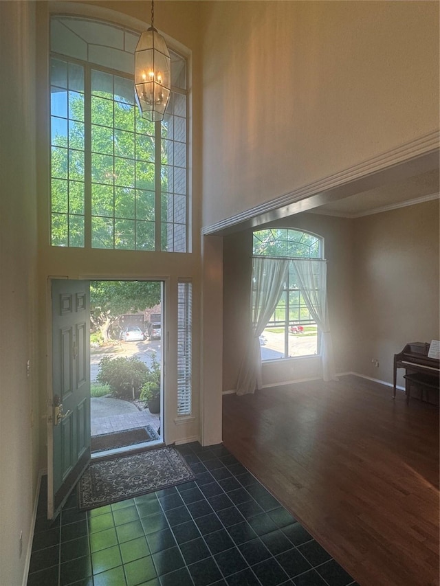2802 Sunrise Dr, Rowlett, TX 75088 - tiled entrance foyer with a chandelier, a towering ceiling, and ornamental molding