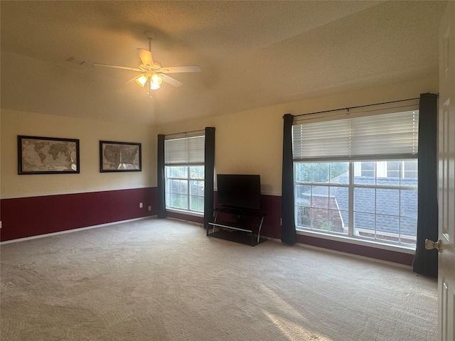 2802 Sunrise Dr, Rowlett, TX 75088 - carpeted living area with a ceiling fan, lofted ceiling, and a textured ceiling