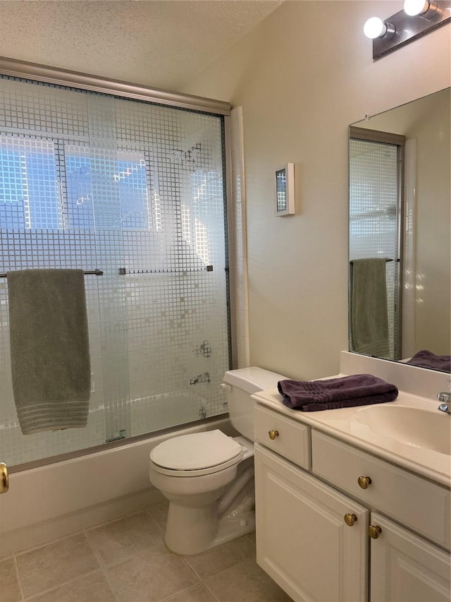 2802 Sunrise Dr, Rowlett, TX 75088 - full bath with vanity, toilet, combined bath / shower with glass door, tile patterned floors, and a textured ceiling