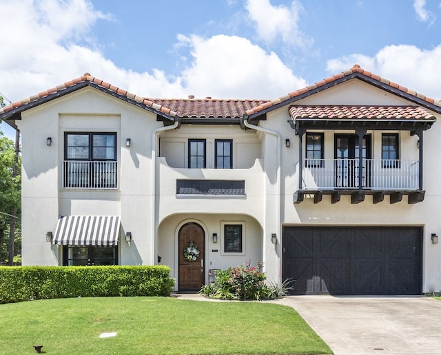 857 N Glasgow Dr Unit C, Dallas, TX 75214 - mediterranean / spanish home with a balcony, an attached garage, a tile roof, a front yard, and driveway