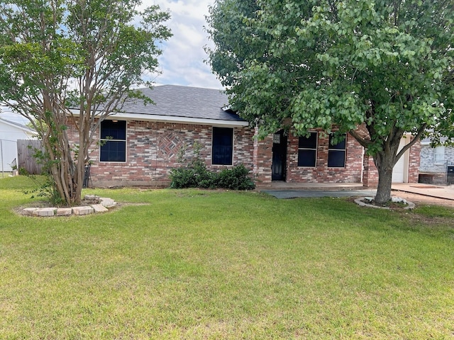 102 Janis St, Alvarado, TX 76009 - view of front of house with a front yard, a garage, brick siding, and roof with shingles