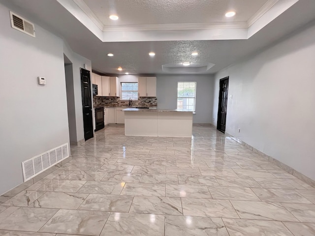 102 Janis St, Alvarado, TX 76009 - kitchen featuring a raised ceiling, crown molding, a sink, decorative backsplash, and white cabinetry