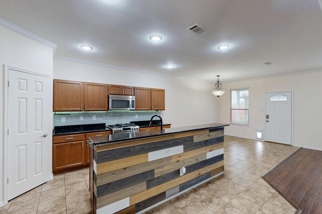 1278 Wysteria Ln, Burleson, TX 76028 - kitchen featuring stainless steel appliances, ornamental molding, dark countertops, backsplash, and brown cabinetry