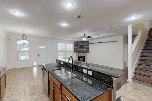 1278 Wysteria Ln, Burleson, TX 76028 - kitchen with a sink, dishwasher, brown cabinets, ceiling fan, and a kitchen island with sink