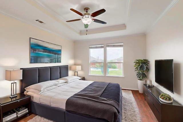 1278 Wysteria Ln, Burleson, TX 76028 - bedroom with a raised ceiling, ornamental molding, light wood-type flooring, ceiling fan, and baseboards