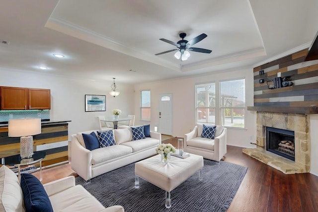 1278 Wysteria Ln, Burleson, TX 76028 - living room with a tray ceiling, plenty of natural light, dark wood-style floors, ornamental molding, and a ceiling fan