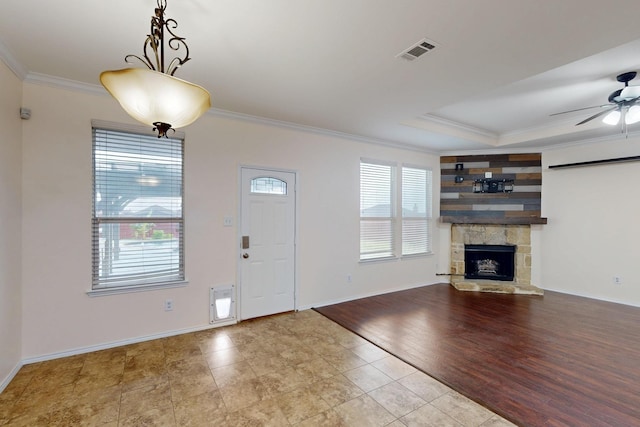 1278 Wysteria Ln, Burleson, TX 76028 - foyer featuring crown molding, a ceiling fan, baseboards, a stone fireplace, and tile patterned flooring