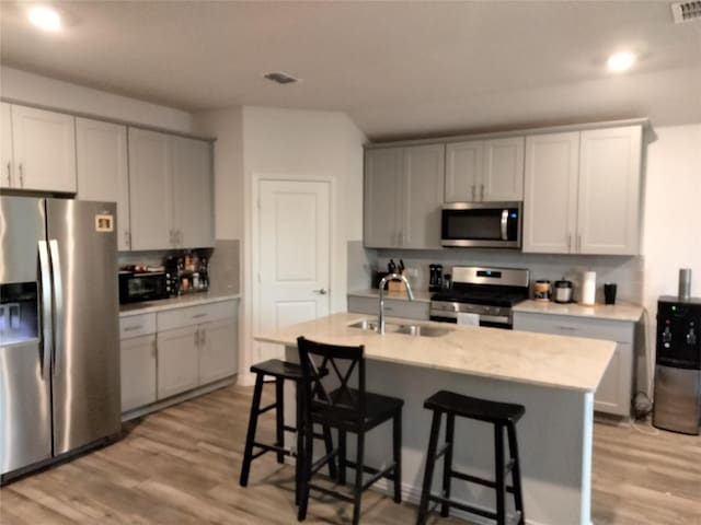 6029 Pathfinder Trl, Fort Worth, TX 76179 - kitchen with appliances with stainless steel finishes, light wood-style flooring, a sink, light countertops, and recessed lighting