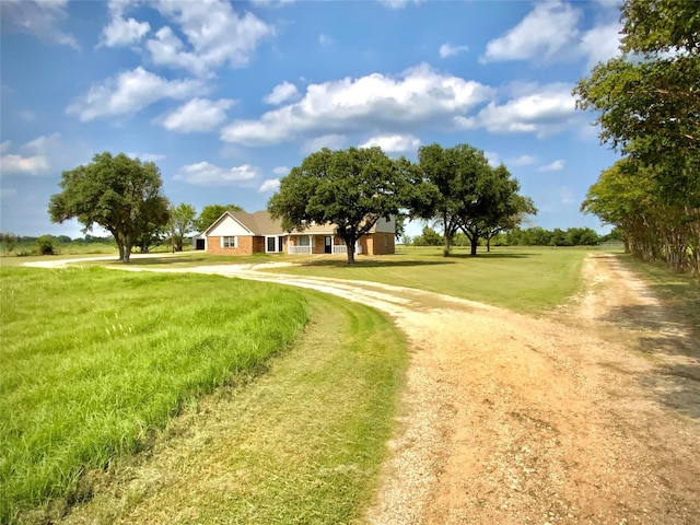1409 W Trinity, Groesbeck, TX 76642 - view of community with curved driveway and a lawn